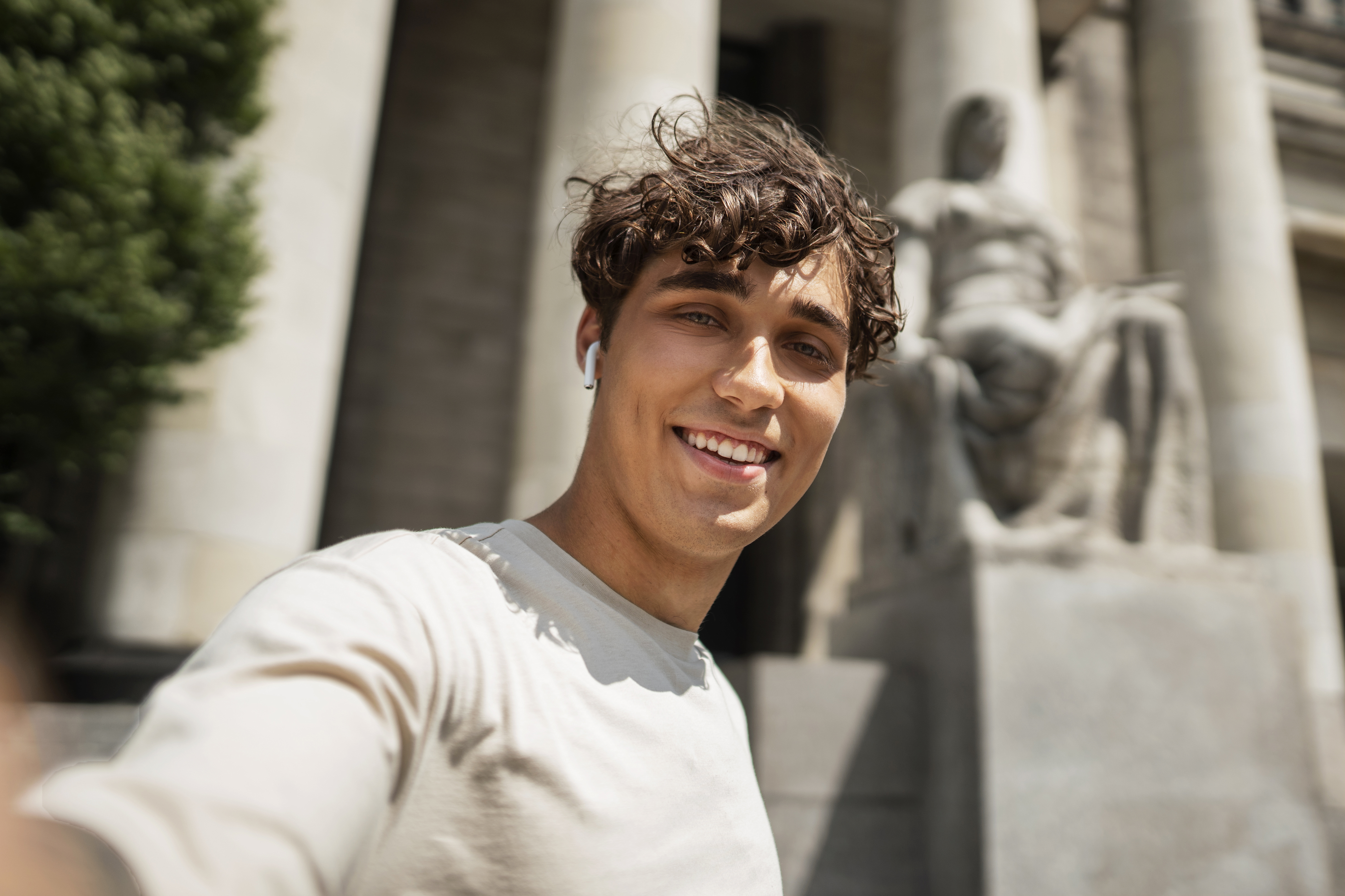 Smiling man taking a selfie outdoors